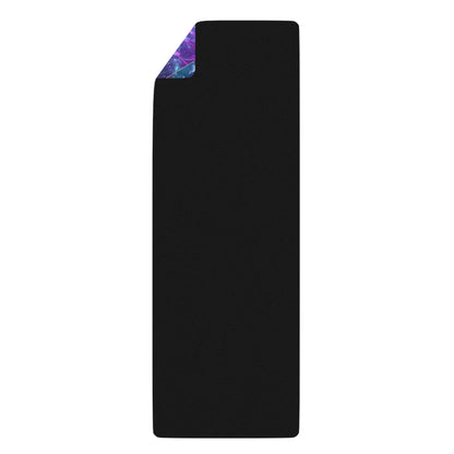 Folded Nectar yoga mat showing its black rubber underside with a corner of the colorful print visible.