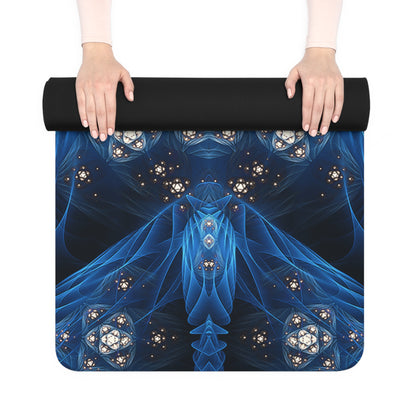 Rolled Inner Sanctum yoga mat held in two hands, showing the black rubber back and blue print edge.