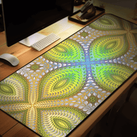 The Activation Initiated desk mat angled on a desk beside a monitor, keyboard, and mouse.