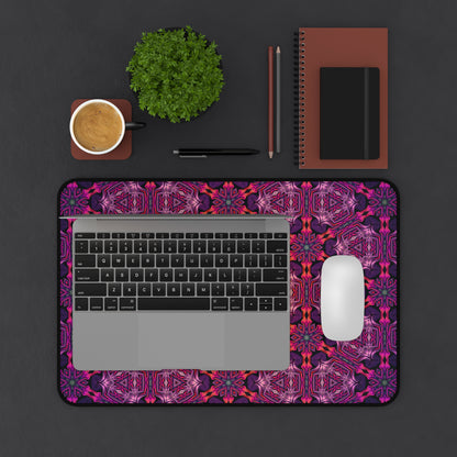 The Forged In Neon desk mat beside an open laptop.
