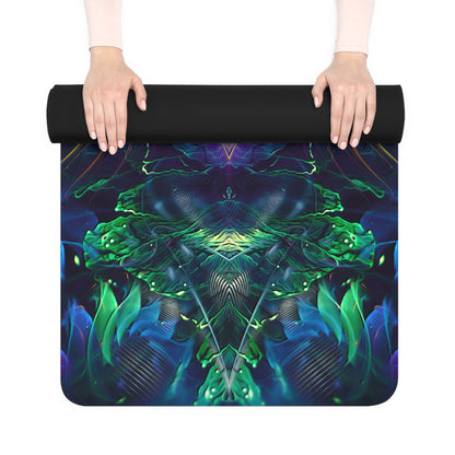 Two hands unrolling the Awakened yoga mat, showing its black rolled top and green-purple printed underside.