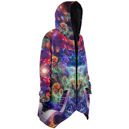 Model wearing the "Magnus Opum" hooded cloak, side profile from the right.