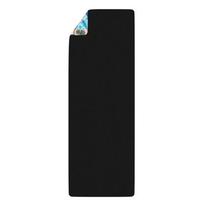Return to Purity yoga mat rolled into a tight cylinder, showing the black rubber underside.