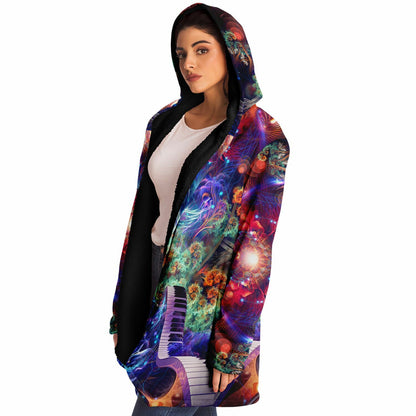 Female model wearing the "Magnus Opum" hooded cloak, side profile from the left.