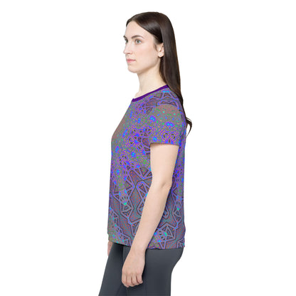 Side view of the Chaos of Tron women's sport tee on a flat surface.