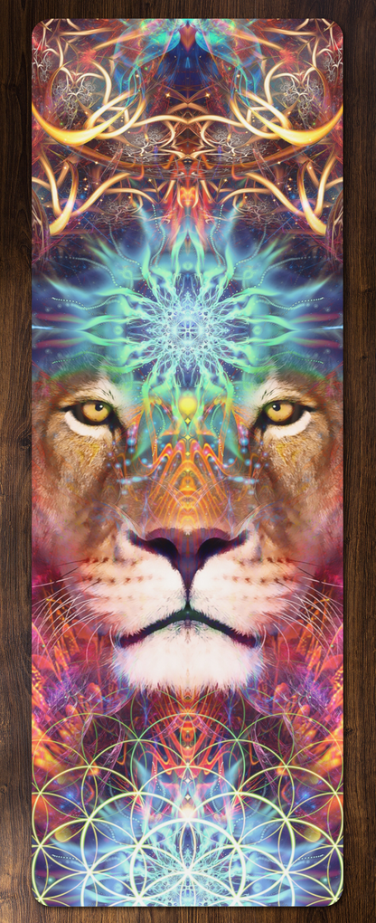 Genesis yoga mat lying flat on a wood floor, showing a symmetrical psychedelic lion face design in purple, teal and gold.