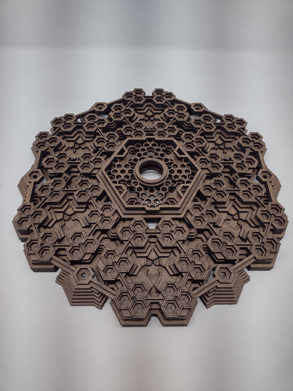 The Fractalgon wall art crystal grid resting on a flat surface, used here as a crystal grid base.