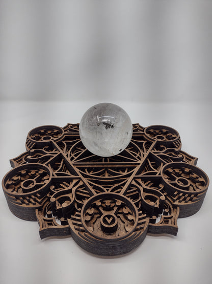 The Harvest Abundance wall art crystal grid laid flat on its raised wooden feet.