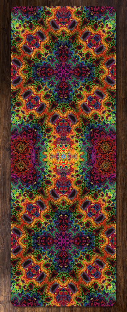 Full view of the Lysergic Burst yoga mat on a wood floor, showing the rainbow kaleidoscope print edge to edge.
