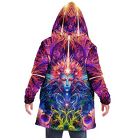 Back view of a male model wearing the Sacred Vine hooded cloak with its ayahuasca vine print.