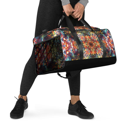 Right-front view of the Kaleidobloom duffle bag with the removable padded strap attached.