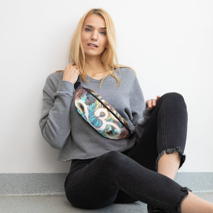 Straight-on front view of the white Density 432 fanny pack with the Om meditation symbol print.