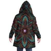 Back view of a man wearing the Multiverse hooded cloak with the hood up, showing the full mandala print down the spine.