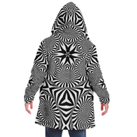 Back view of a male model wearing The Illusionist hooded cloak with the hood up, showing the black and white spiral print.