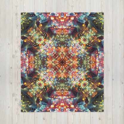 Another front view of the folded Kaleidobloom fractal mandala throw blanket showing the print in full.