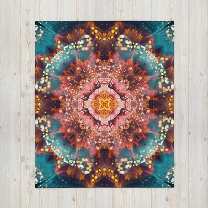 Another front view of the folded Reaching for Light floral mandala throw blanket showing the print in full.