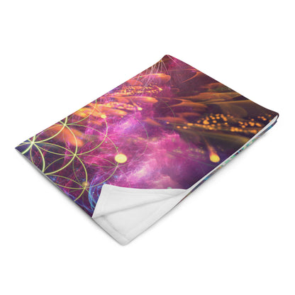 "Genesis" throw blanket photographed at an angle, showing print and fabric drape.