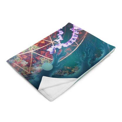 "Primordial Soup" throw blanket photographed at an angle, showing print and fabric drape.