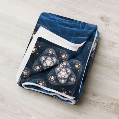 "Inner Sanctum" throw blanket styled across a bed, showing size and drape.