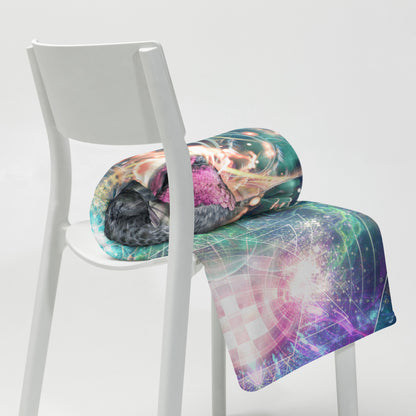 Lifestyle photo of the Nectar hummingbird spirit animal throw blanket styled in a home setting.