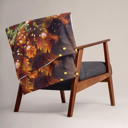 "Autumn Bloom" throw blanket folded at the foot of a bed, showing the soft texture.