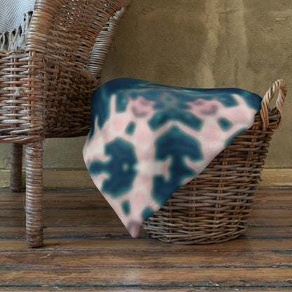 The "Triple Goddess" throw blanket draped over a couch, corner folded to show the white reverse side