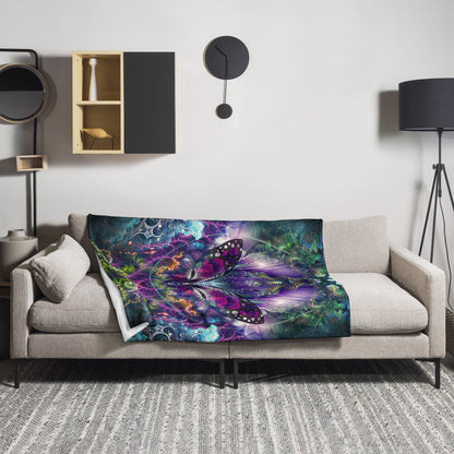 The "Emergence" throw blanket draped over a couch, corner folded to show the white reverse side