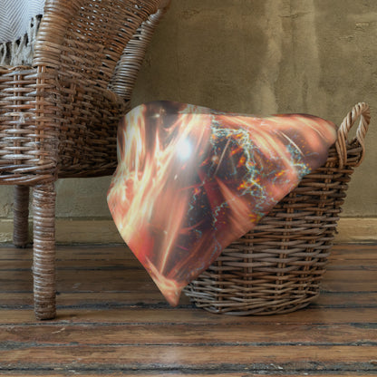 Muladhara root chakra mandala throw blanket folded at the foot of a bed in a bedroom lifestyle setting.