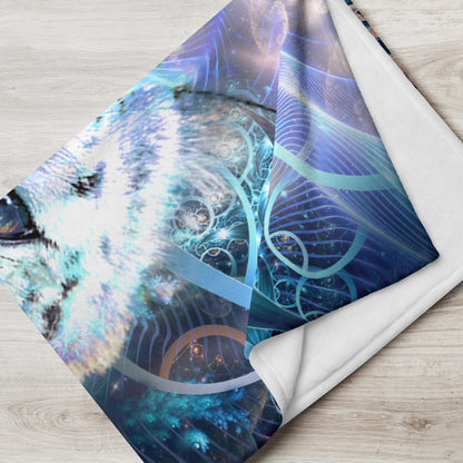 The Solitude throw blanket folded across the arm of a chair, revealing the psychedelic snow leopard artwork.