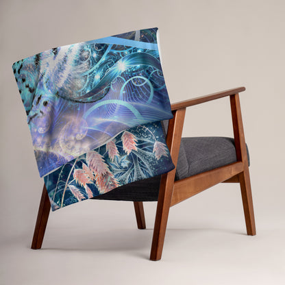 The Solitude throw blanket wrapped around a person's shoulders, showing the snow leopard design up close.