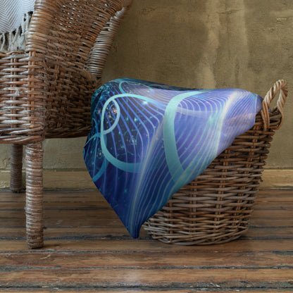 The Solitude throw blanket hung over a railing, showing the snow leopard print in natural light.
