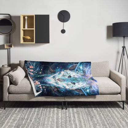The Solitude throw blanket draped over a couch, showing how the snow leopard design drapes in a living room.
