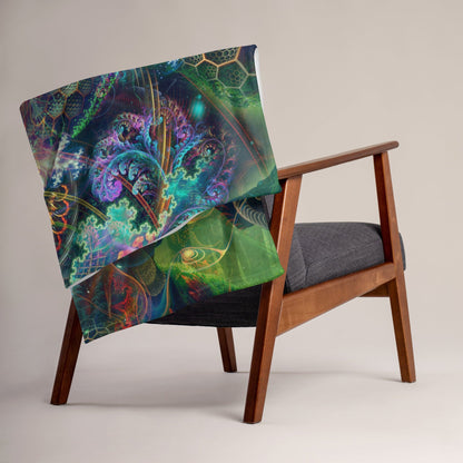 Tree of Life throw blanket folded over the back of a couch showing its trippy print in a home setting.