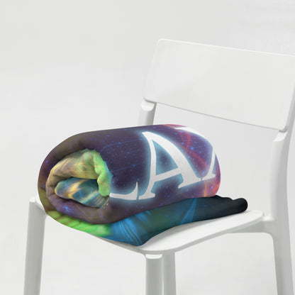 The Relax fractal typography throw blanket shown draped over furniture at home.
