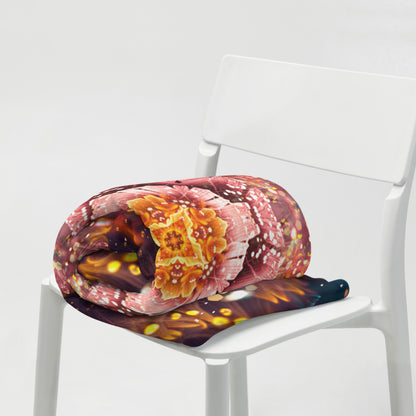 The Reaching for Light floral mandala throw blanket styled in a cozy living room setting.