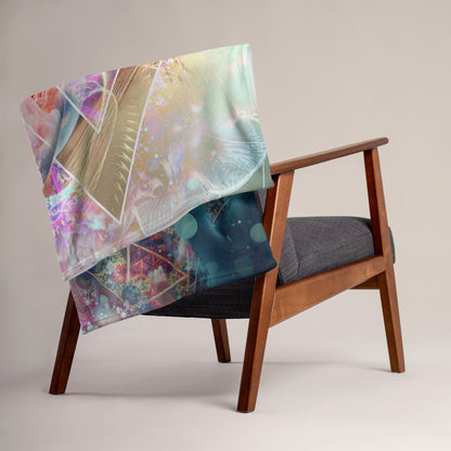 "Primordial Soup" throw blanket folded at the foot of a bed, showing the soft texture.