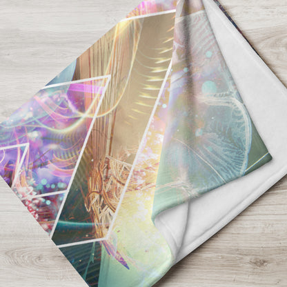 "Primordial Soup" psychedelic jellyfish throw blanket draped over a couch in a living room.