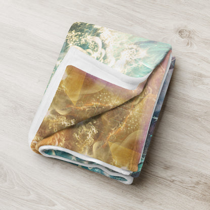 The "Celestial Vibrations" throw blanket draped over a couch, corner folded to show the white reverse side