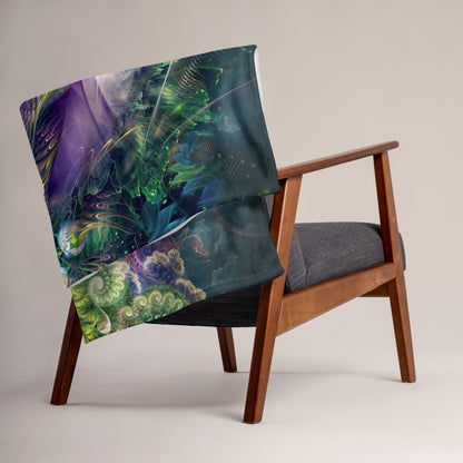 The "Emergence" throw blanket draped over a couch, corner folded to show the white reverse side