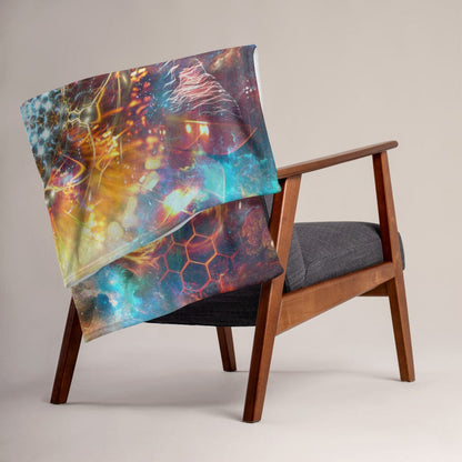"The Wanderers" throw blanket draped over a couch, corner folded to show the white reverse side